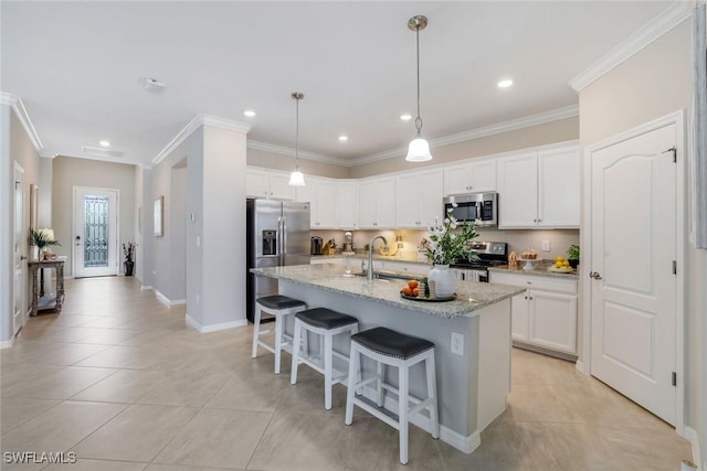 kitchen featuring light tile patterned floors, crown molding, stainless steel appliances, and a sink