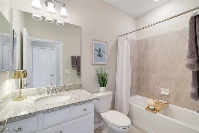 bathroom featuring toilet, shower / tub combo with curtain, and vanity