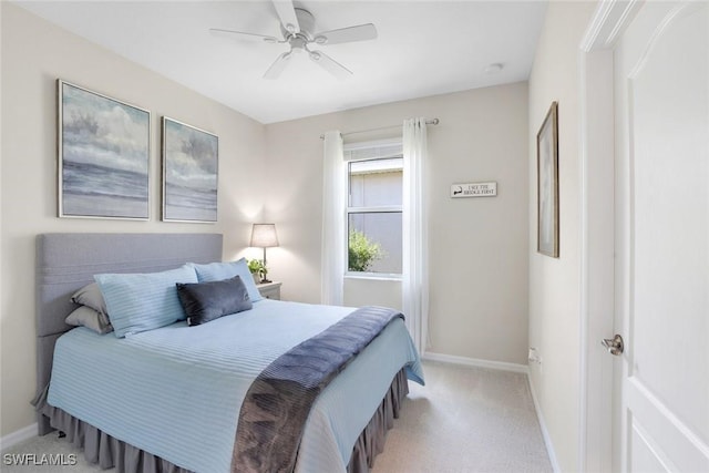 bedroom with a ceiling fan, carpet flooring, and baseboards