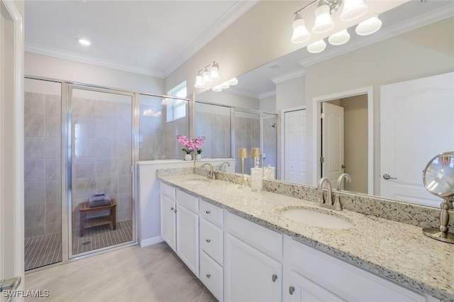 full bath featuring crown molding, a stall shower, a sink, and double vanity