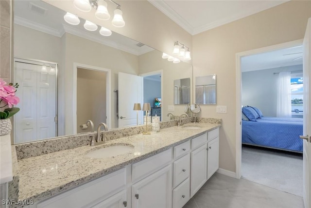 full bathroom with crown molding, connected bathroom, a sink, and double vanity