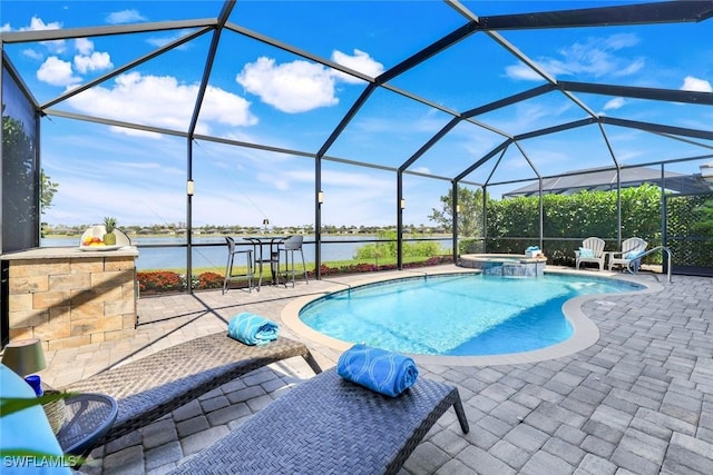 view of pool featuring a water view, a patio area, a pool with connected hot tub, and a lanai