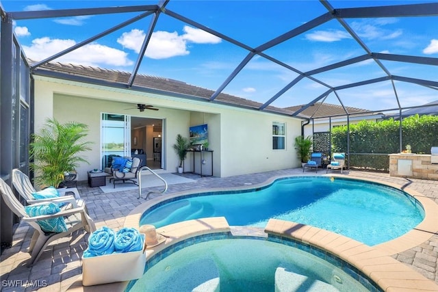 view of swimming pool with a pool with connected hot tub, glass enclosure, and a patio