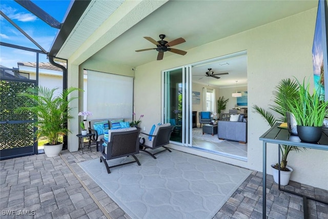 view of patio with a lanai, ceiling fan, and an outdoor living space