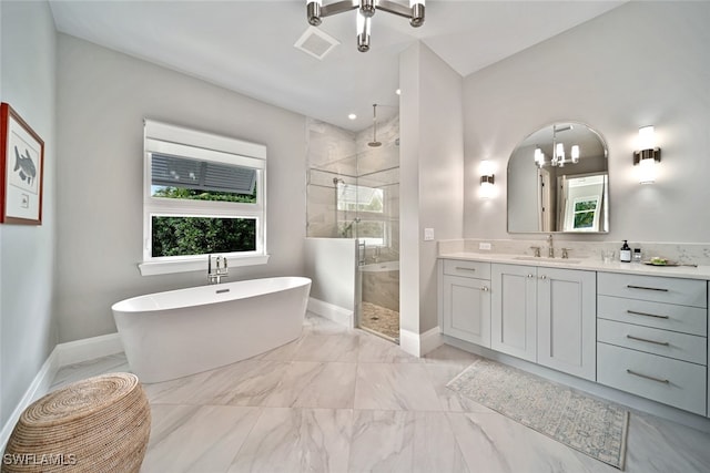 bathroom with shower with separate bathtub, a chandelier, and vanity