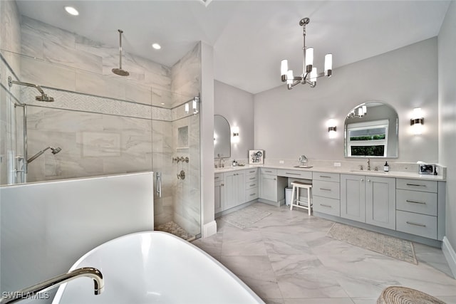 bathroom featuring independent shower and bath, a chandelier, and vanity