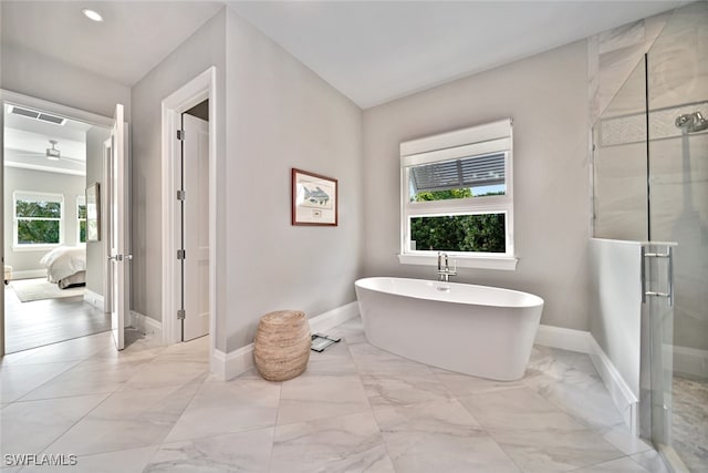 bathroom with separate shower and tub and plenty of natural light