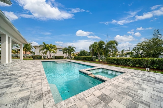 view of swimming pool with an in ground hot tub and a patio area