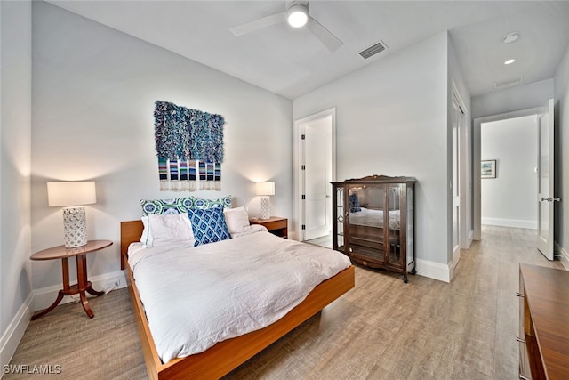 bedroom with ceiling fan and light wood-type flooring