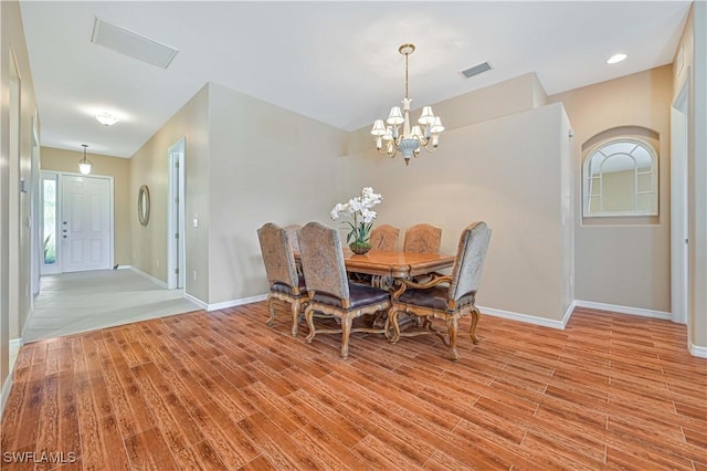 dining room with a chandelier and light hardwood / wood-style floors