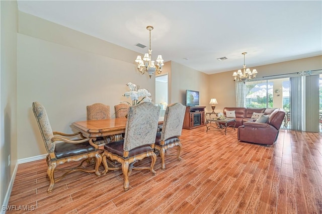 dining area featuring a chandelier and light hardwood / wood-style floors