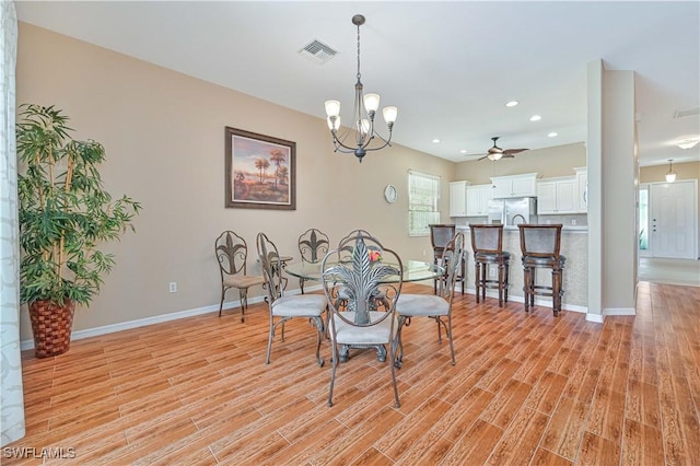 dining area with a chandelier and light hardwood / wood-style floors