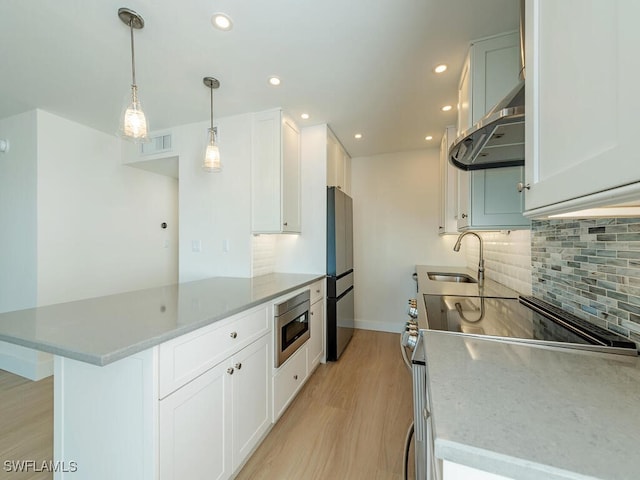 kitchen featuring white cabinetry, appliances with stainless steel finishes, sink, and exhaust hood