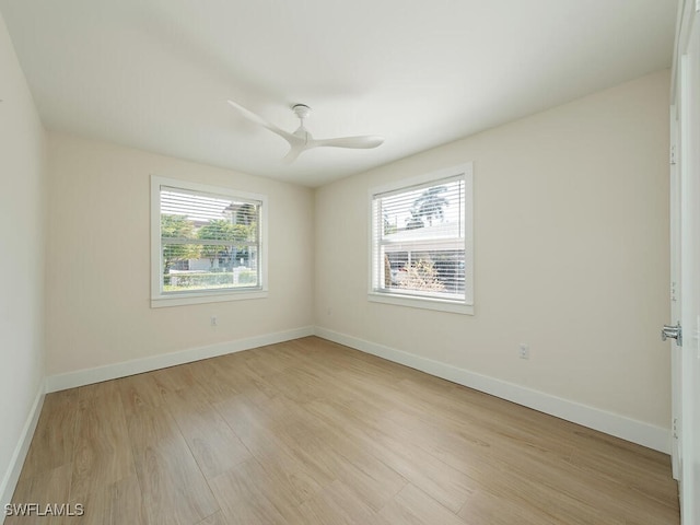 empty room with light hardwood / wood-style flooring, plenty of natural light, and ceiling fan