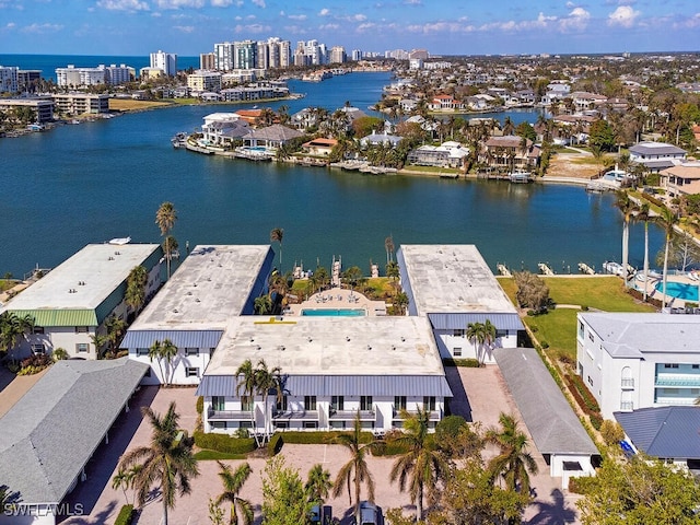drone / aerial view featuring a water view and a residential view
