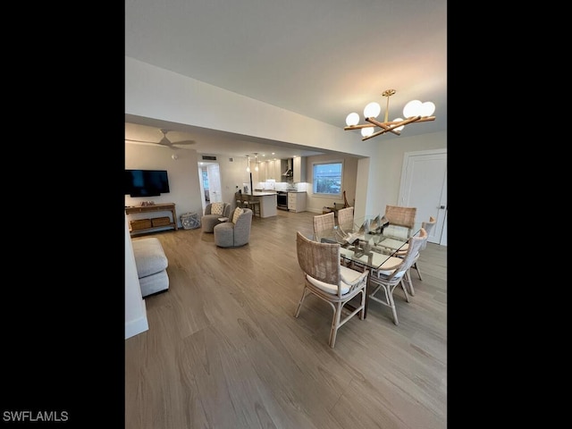 dining area featuring hardwood / wood-style flooring and a chandelier