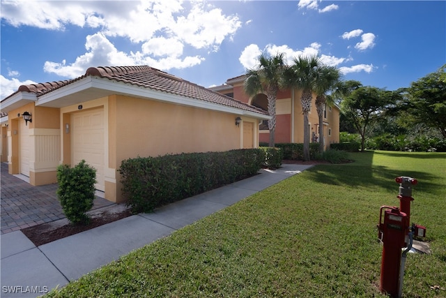 view of property exterior with a garage and a yard