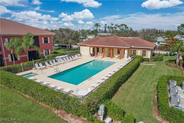 view of swimming pool with a yard and a patio area