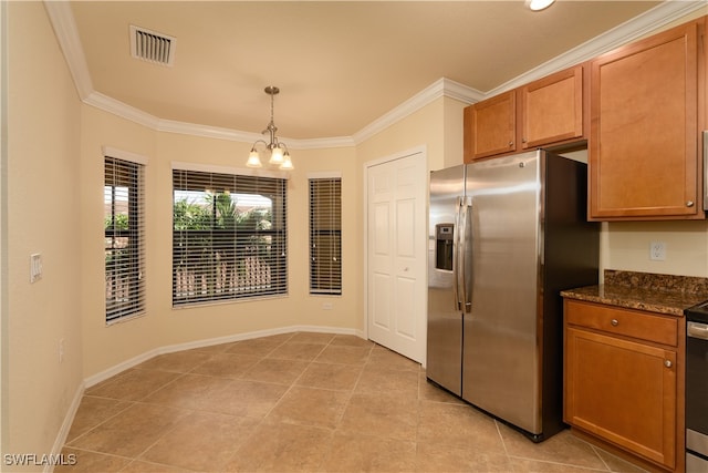 kitchen with appliances with stainless steel finishes, decorative light fixtures, a notable chandelier, and crown molding