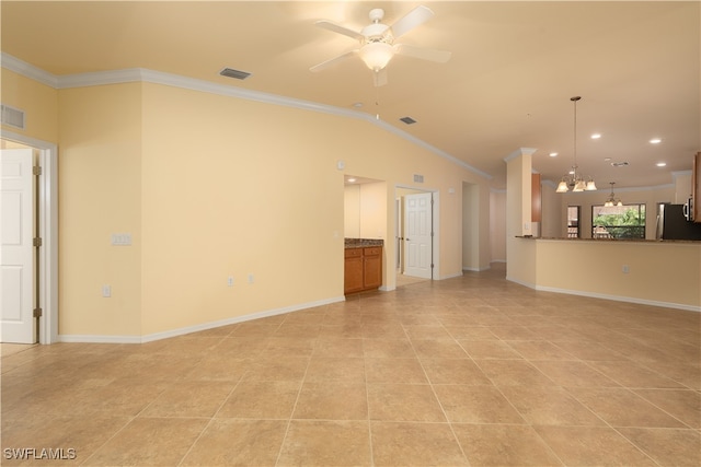 unfurnished living room with ceiling fan with notable chandelier, light tile patterned floors, vaulted ceiling, and ornamental molding