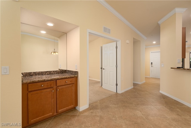 hallway with light tile patterned flooring and ornamental molding