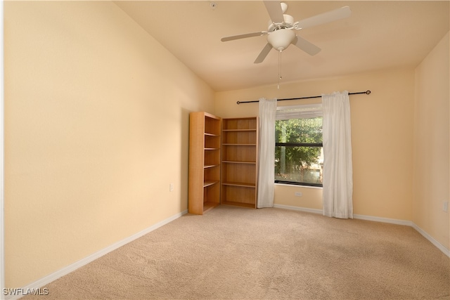 empty room featuring carpet, lofted ceiling, and ceiling fan