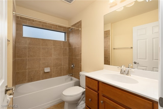 full bathroom with tiled shower / bath, toilet, and vanity