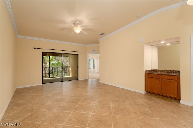 tiled spare room with ceiling fan and crown molding