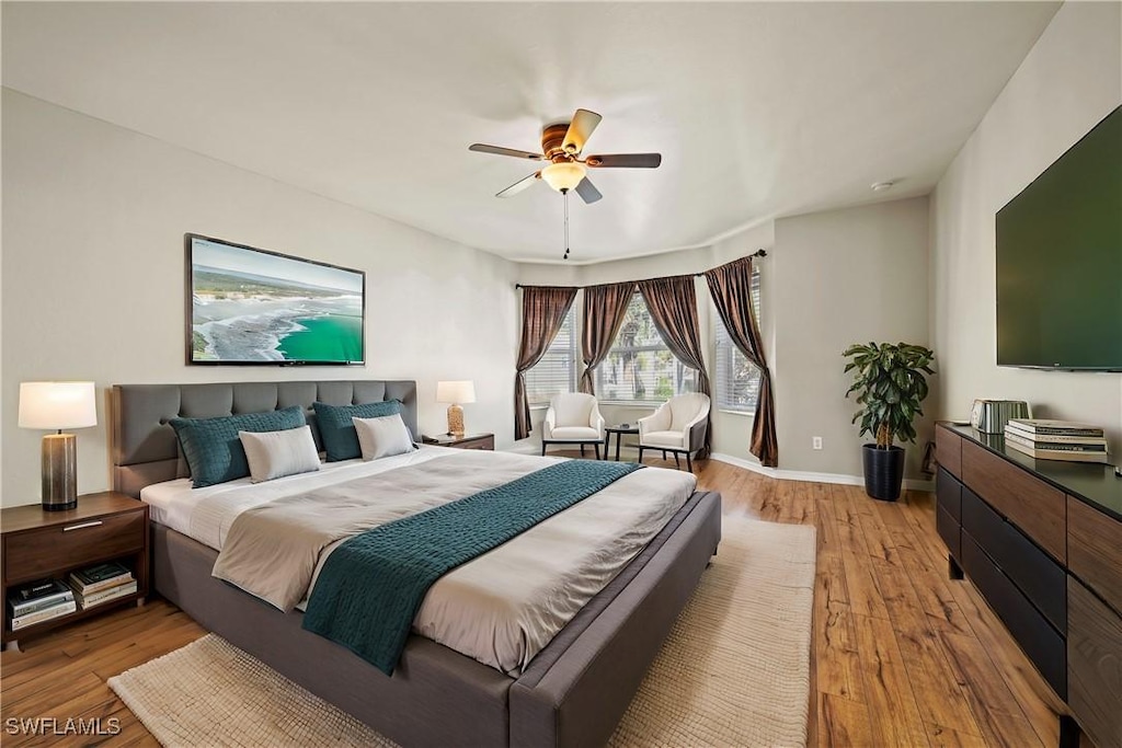 bedroom with ceiling fan and light hardwood / wood-style flooring