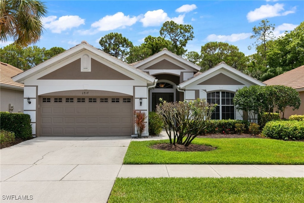 ranch-style house with a garage and a front yard