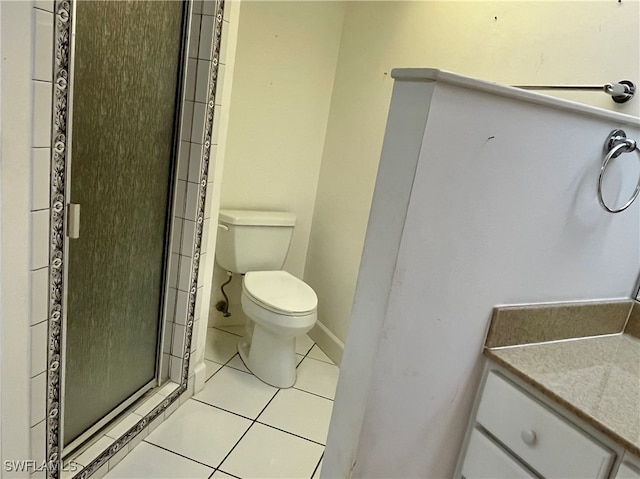 bathroom with vanity, a shower with shower door, tile patterned flooring, and toilet