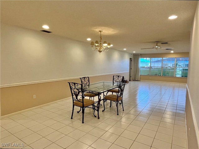 dining area featuring ceiling fan with notable chandelier and light tile patterned floors