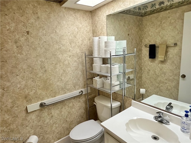 bathroom with toilet and vanity