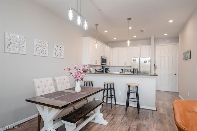 dining area with dark wood-type flooring