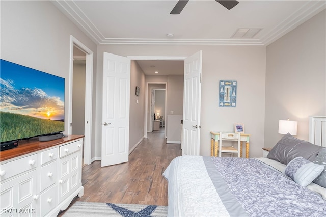 bedroom with hardwood / wood-style floors, ceiling fan, and crown molding