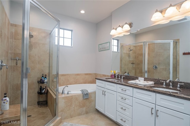 bathroom featuring tile patterned floors, vanity, and plus walk in shower