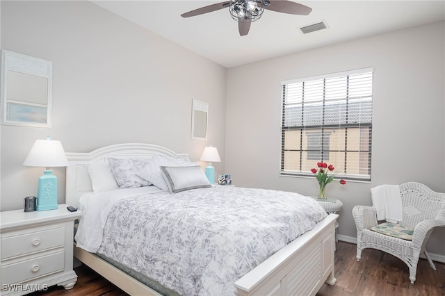 bedroom with dark hardwood / wood-style flooring and ceiling fan