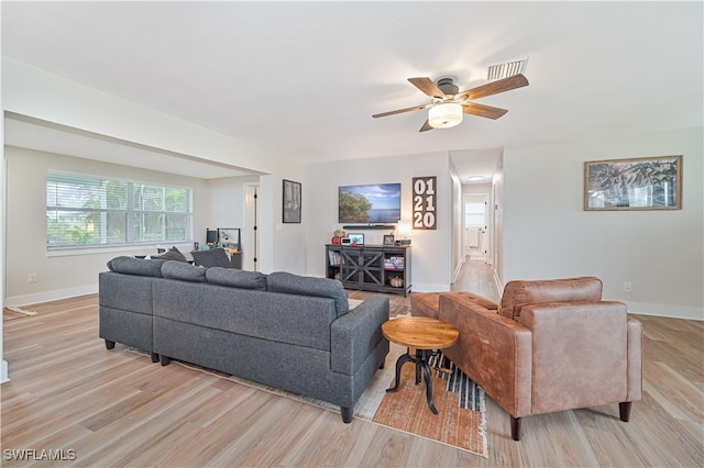 living room with light hardwood / wood-style flooring and ceiling fan