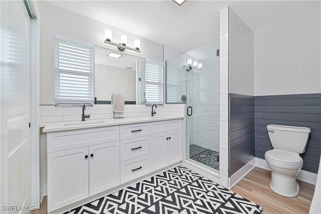 bathroom with hardwood / wood-style floors, an enclosed shower, vanity, and toilet