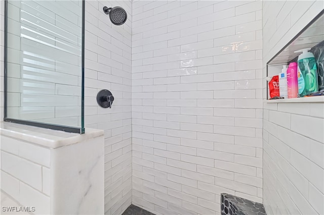 bathroom with a tile shower