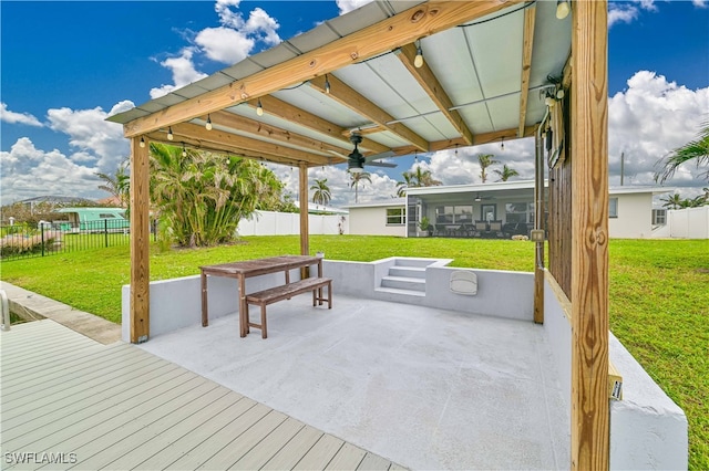 view of patio / terrace featuring a sunroom and ceiling fan