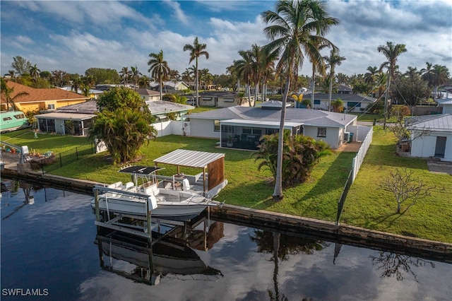 view of dock featuring a water view and a lawn