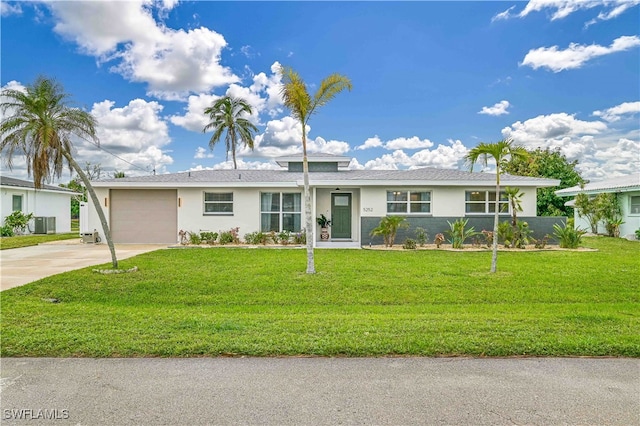 ranch-style house with a garage, a front yard, and central AC