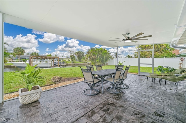 view of patio featuring a water view and ceiling fan