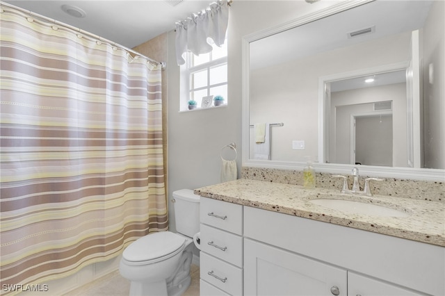 bathroom with vanity, tile patterned floors, and toilet