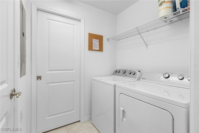 washroom featuring washer and clothes dryer and light tile patterned floors