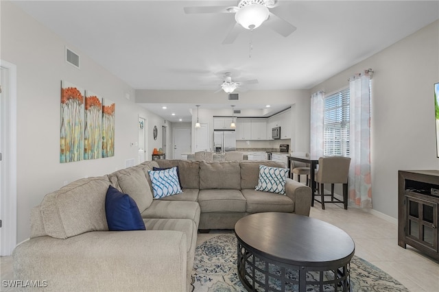 tiled living room with ceiling fan