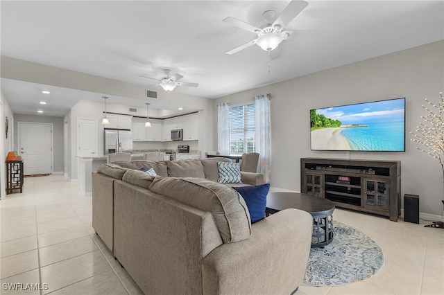 living room with ceiling fan and light tile patterned floors