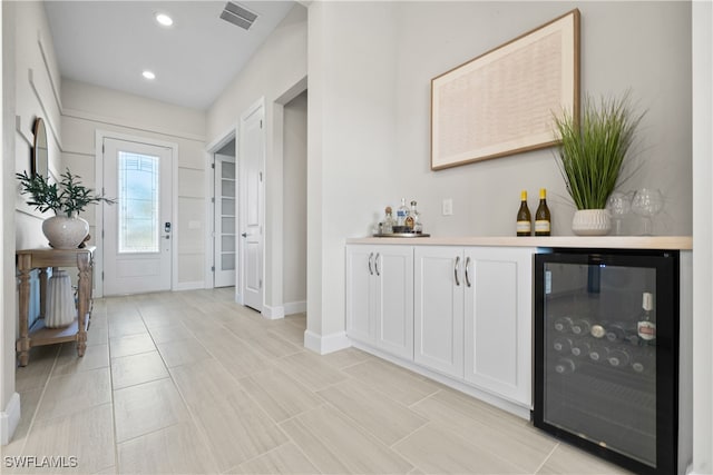 foyer featuring beverage cooler and bar area