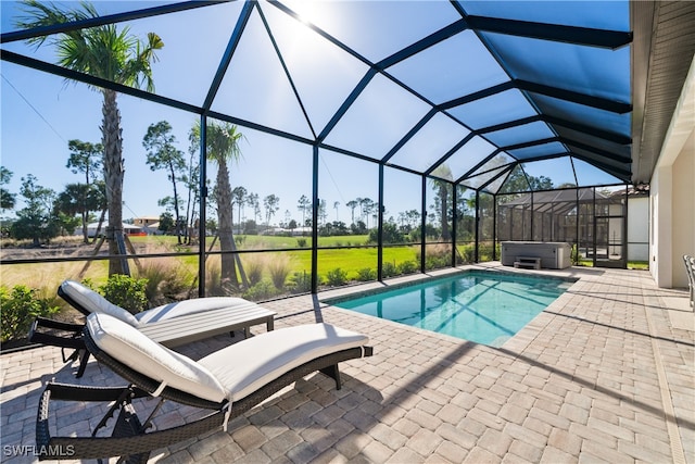 view of pool with a patio area, a lanai, and a hot tub